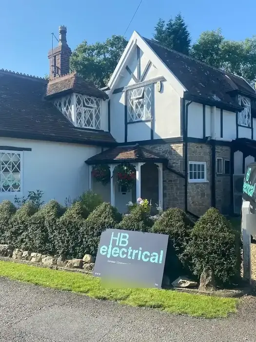 HB Electrical branded van and HB sign on the front lawn of a detached Tudor-style house in Bristol