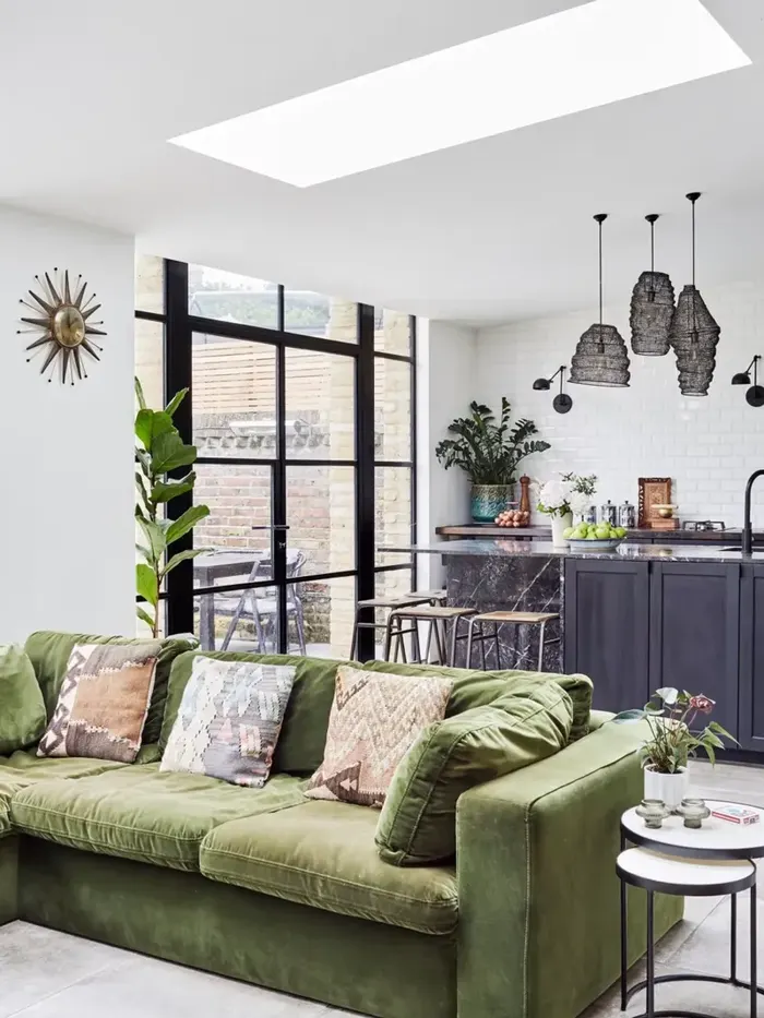 Bright open-plan living space with a skylight and glazed doors opening onto the garden