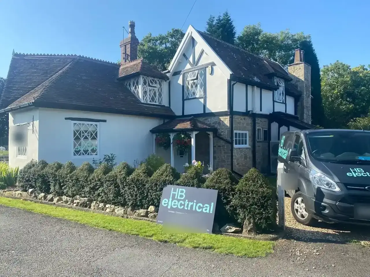 HB Electrical van and HB sign outside a detached Tudor-style house
