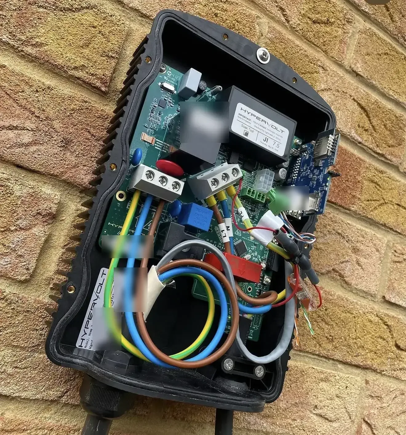 Hypervolt EV charger with the cover off showing terminal wiring during installation